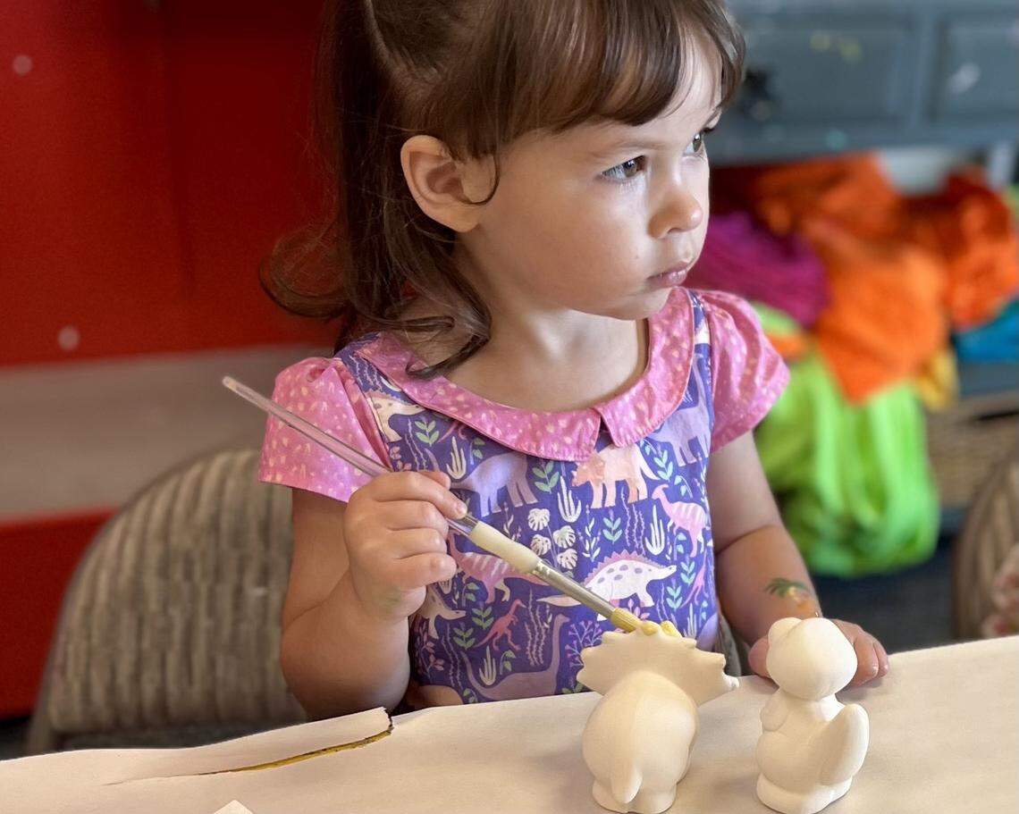 Maylinn Lacen, daughter of owner Cami Hacen, works on her figurines at Potter’s Haven.