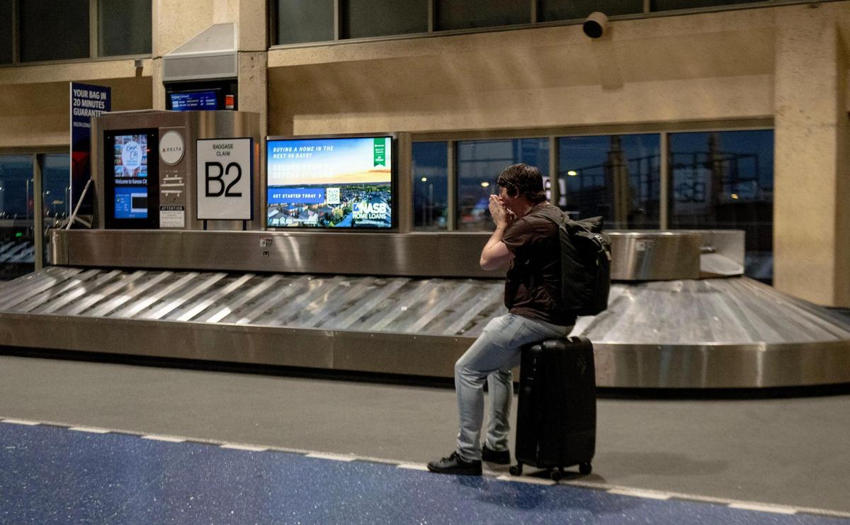 Zac Shaw yawns while waiting inside terminal B on the last day of operation at Kansas City International Airport’s old terminals on Monday, Feb. 27, 2023, in Kansas City.