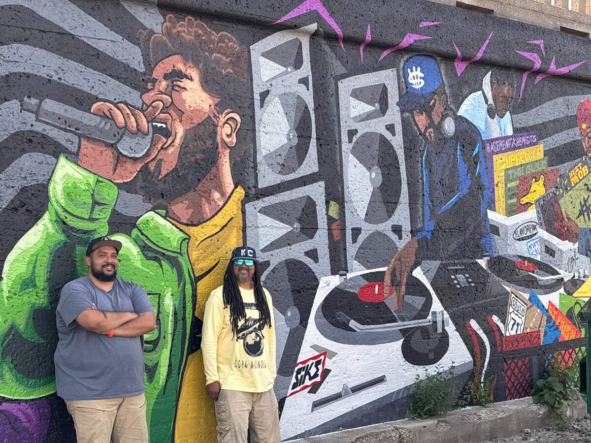 Kansas City artists JT Daniels and Phil Shafer were commissioned to create a 250-foot mural at 2000 Vine Street in Kansas City’s 18th and Vine District. The piece traces Black music from African roots to jazz and hip-hop, honoring local creators.