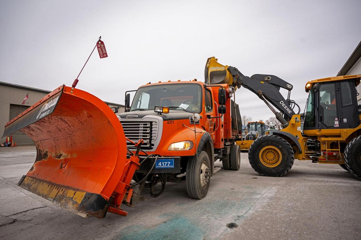 A snowplow driver waits as a front-end loader fills his truck with salt at the Kansas City Public Works Department on Saturday, Jan. 4, 2025. The city is ready for one of its biggest winter storms in years, with 40,000 tons of salt, 8,000 tons of IceBan, 36,000 gallons of calcium chloride, 300 snowplows, and 400 drivers.