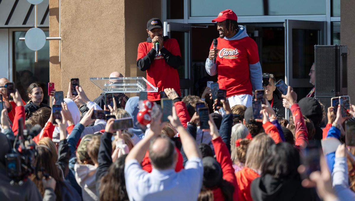 Kansas City Chiefs receiver Mecole Hardman Jr., left, and cornerback L’Jarius Sneed address fans gathered outside while working at a Raising Cains restaurant in Blue Springs on Tuesday.