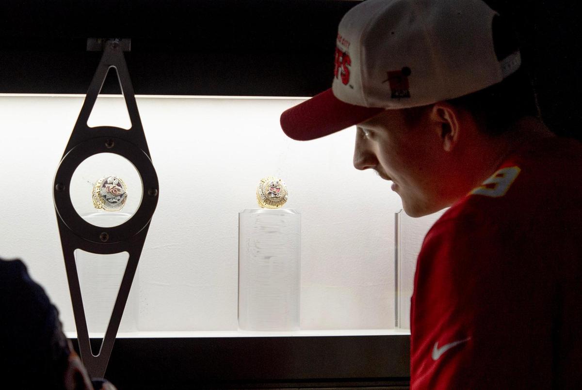 Jack Widman of Phoenix looks at the Kansas City Chiefs 2020 Super Bowl ring at the NFL’s Super Bowl Experience on Thursday, Feb. 9, 2023, in Phoenix.