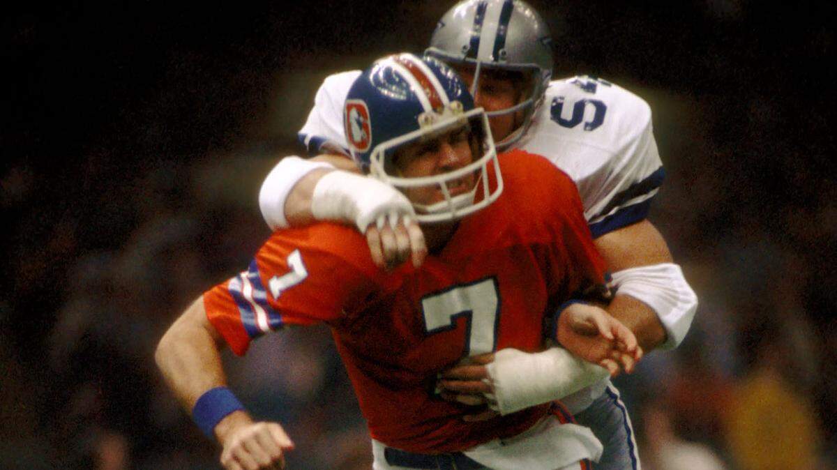 Dallas Cowboys defensive tackle #54 Randy White pressures Denver Broncos quarterback #7 Craig Morton during Super Bowl XII at the Superdome.