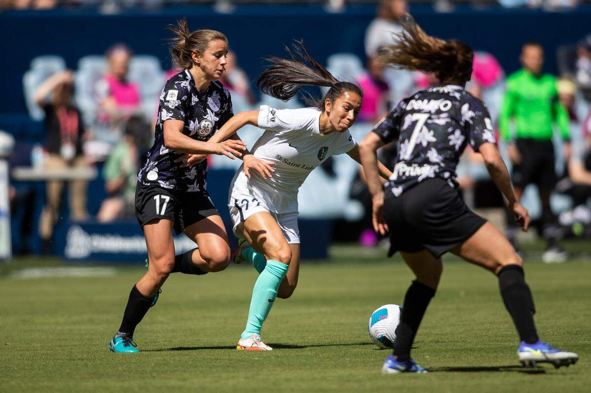 KC defender Alex Loera (No. 22) fights through the visitors’ defense during Saturday’s home opener between the KC Current and Racing Louisville at Children’s Mercy Park in Kansas City, Kan.