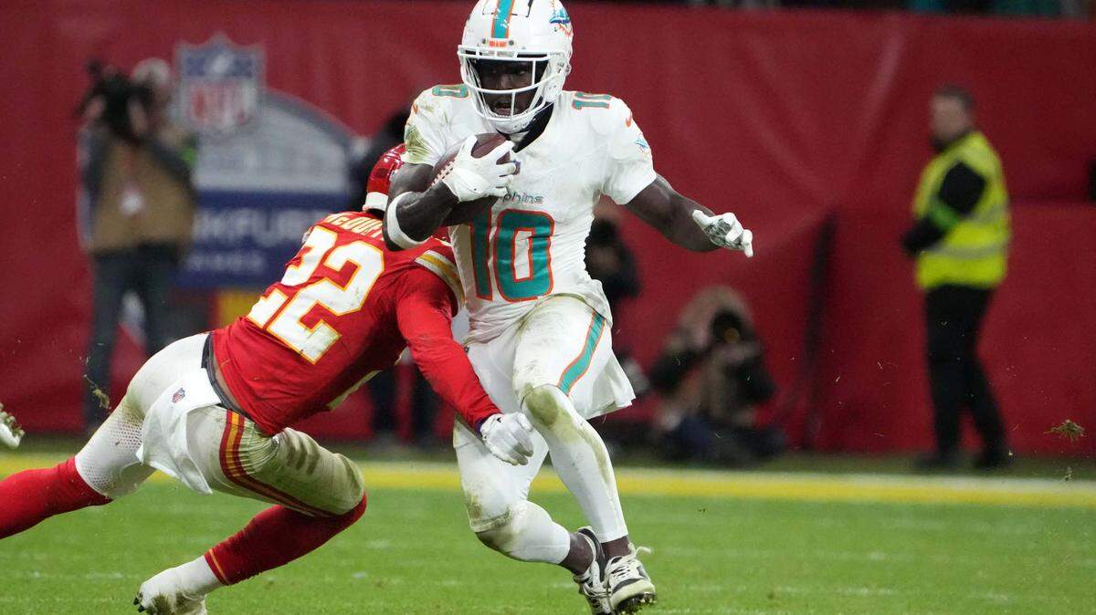 Miami Dolphins wide receiver Tyreek Hill (10) carries the ball against Kansas City Chiefs cornerback Trent McDuffie in the second half during an NFL International Series game at Deutsche Bank Park.