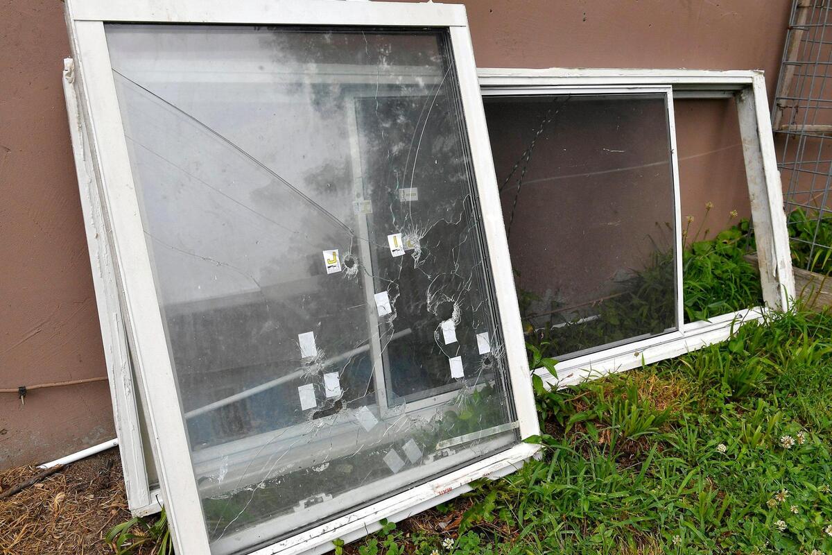 A window with several bullet holes in it was placed against the house where Kaitlyn Mahurin, 20, was shot and killed on June 20th. Rosilyn Temple, the Founder and Program Director for KC Mothers in Charge, went door to door Thursday afternoon distributing information and talking with residents about the shooting that ocurred in the 2600 block of Cypress Ave.