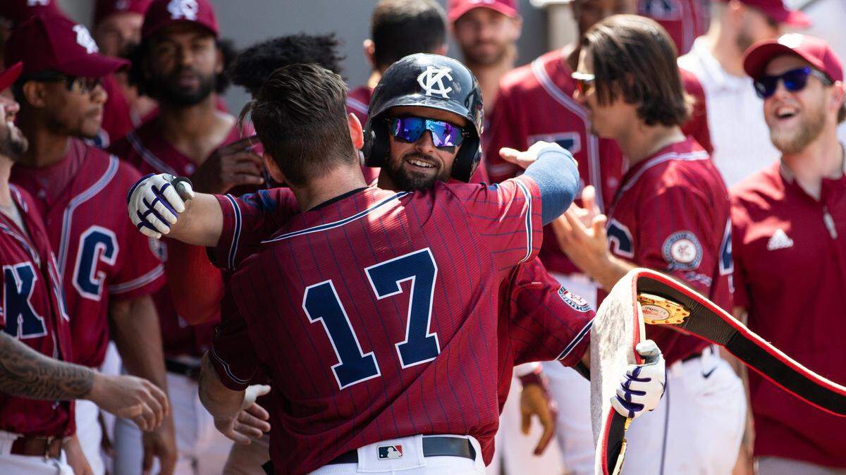 Kansas City Monarchs shortstop LJ Hatch hugs teammate Gavin Collins (No. 17) after hitting a home run on June 7.