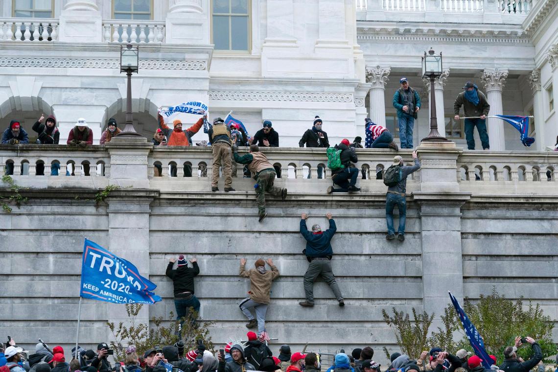 President Donald Trump’s supporters climb the west wall of the the U.S. Capitol on Wednesday, Jan. 6, 2021, in Washington.