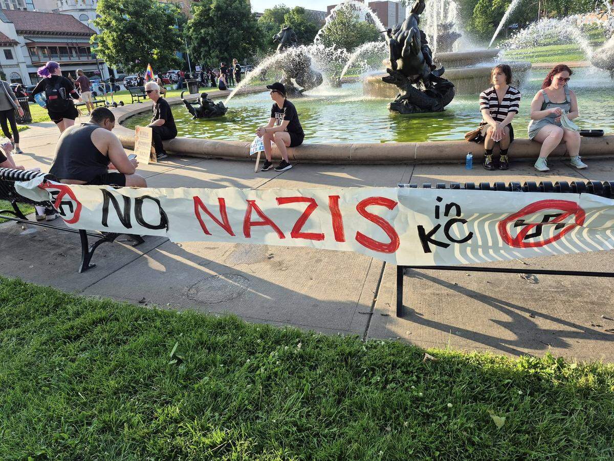 A photo of some protestors sitting at Mill Creek Park before the march.