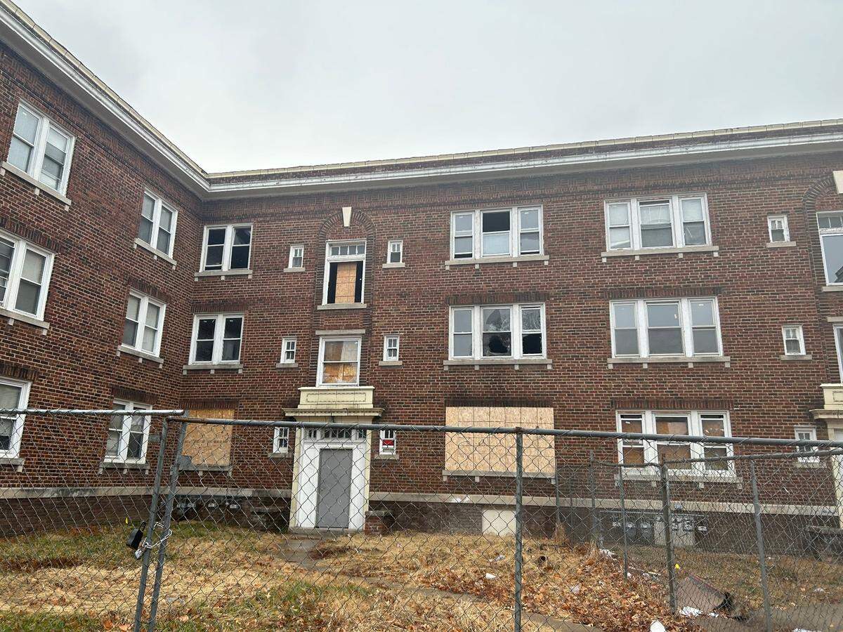 Residents live in an apartment complex on Lawn Avenue in northeast Kansas City, despite its boarded-up windows and lack of heat.