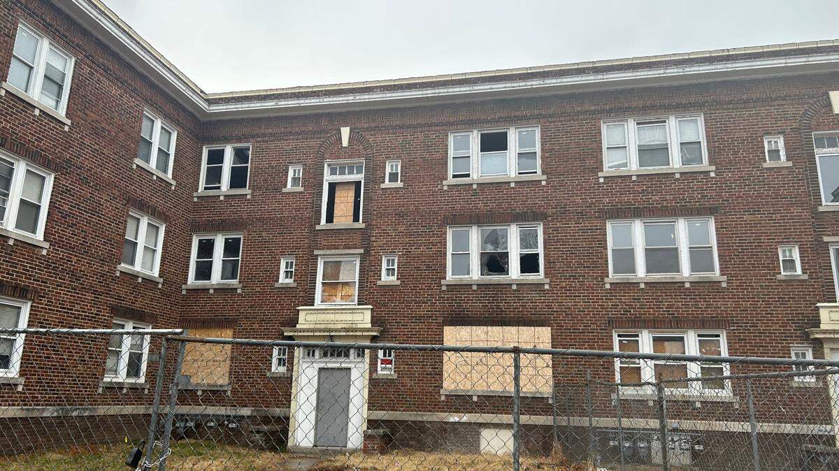 Residents live in an apartment complex on Lawn Avenue in northeast Kansas City, despite its boarded-up windows and lack of heat.