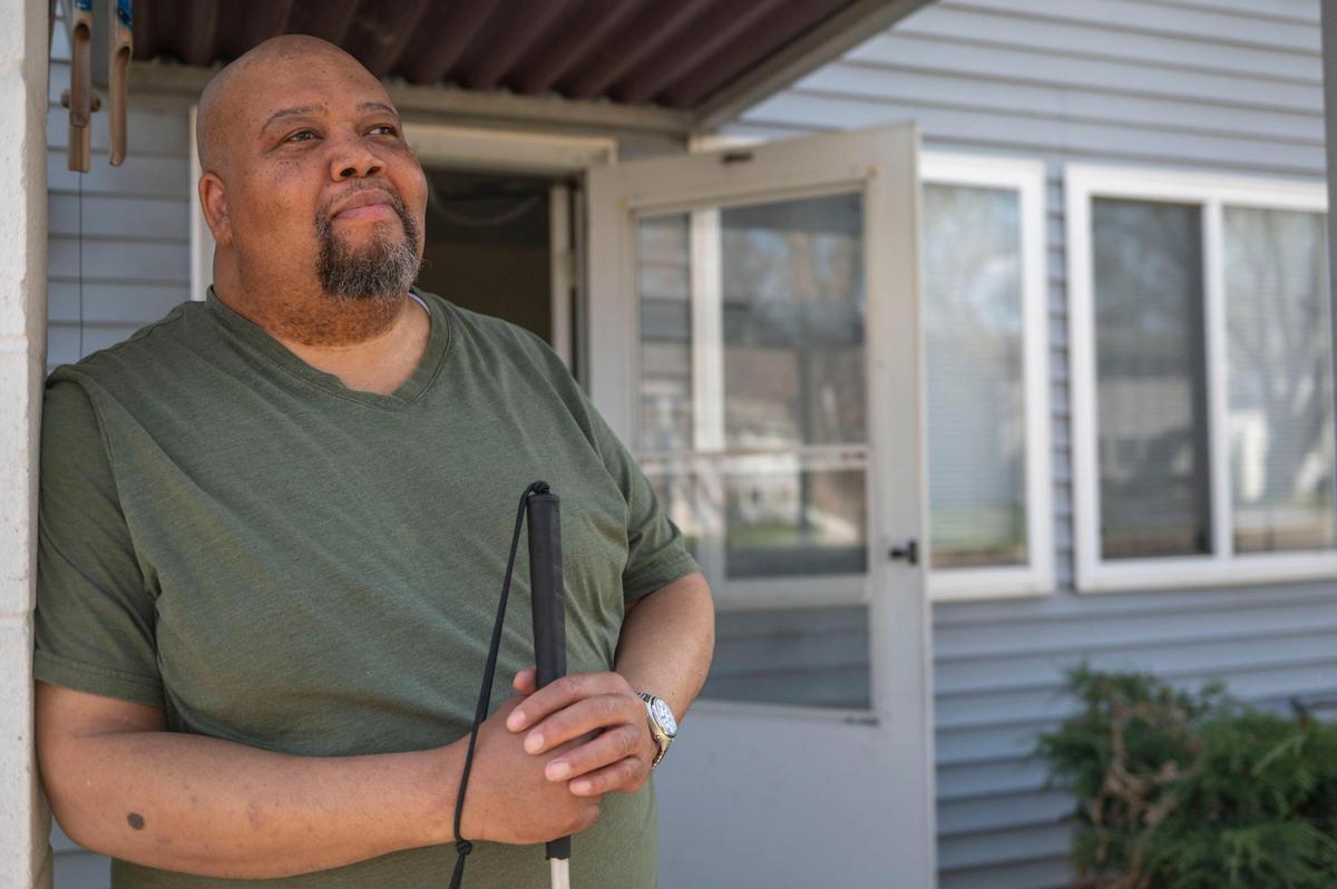 Darrin Sherman stands outside his front door at his apartment in Kansas City on Tuesday, April 12, 2022. Sherman, a resident of Parade Park Homes, is the latest resident to leave Parade Park, as many units have allegedly been neglected by a property management company that oversees it.