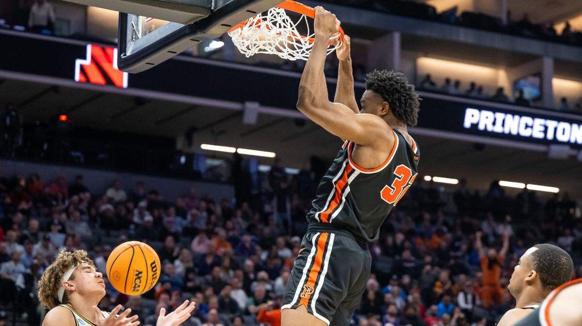Missouri Tigers forward Noah Carter (35), left, catches the ball after Princeton Tigers forward Keeshawn Kellman (32) slam dunks the ball during the first half of their NCAA Tournament game at Golden 1 Center on Saturday, March 18, 2023, in Sacramento.