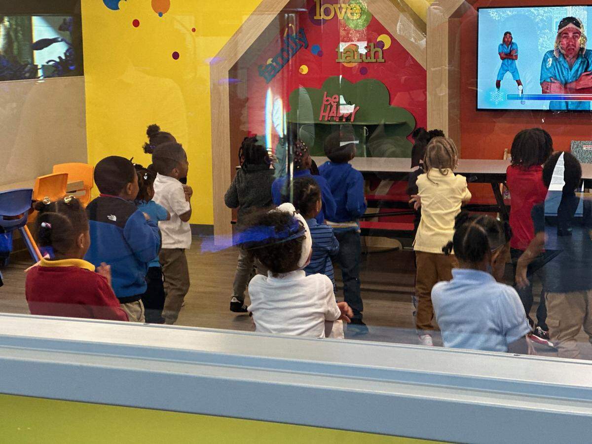 Children dance to a video in a classroom at KD Academy on 2141 Prospect Avenue on Wednesday, Oct. 22, after a news conference where Kansas City officials announced a new childcare program where the City and the state of Missouri pay for two-thirds of childcare costs for first responders.