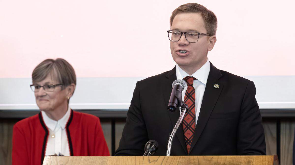 Lt. Gov. David Toland, who led the state's negotiations with the Kansas City Chiefs, stands with Gov. Laura Kelly to comment on the team's historic move to Kansas during an event in Topeka on Monday, Dec. 22, 2025. The event announced the franchise will depart Arrowhead Stadium for a new $3 billion domed facility in Kansas City, Kansas, scheduled to open for the 2031 season