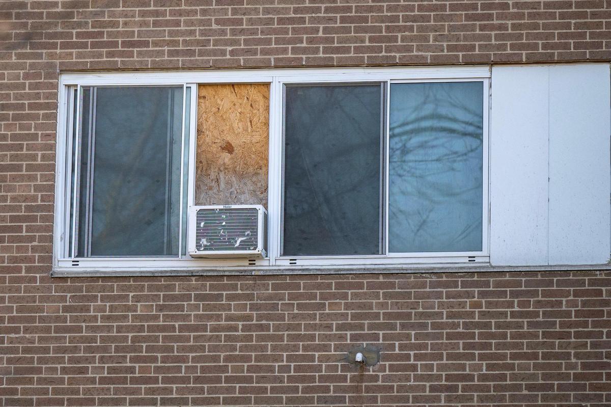 A boarded-up window is seen at the Independence Towers on March 19.