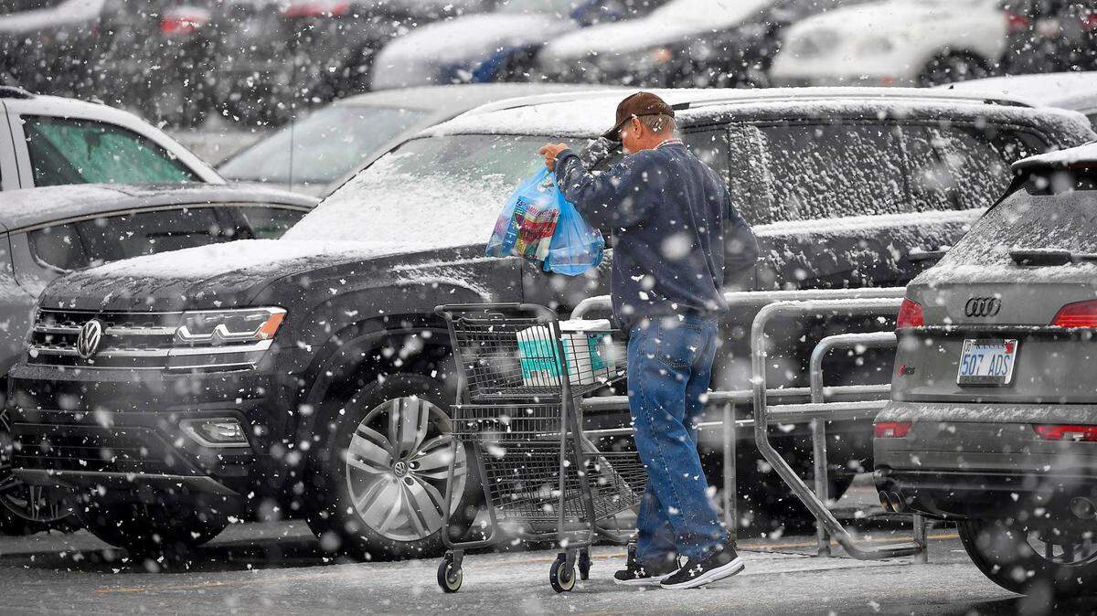 Snow fell on a shopper in a grocery store parking lot in Shawnee, Kansas, in January 2024.