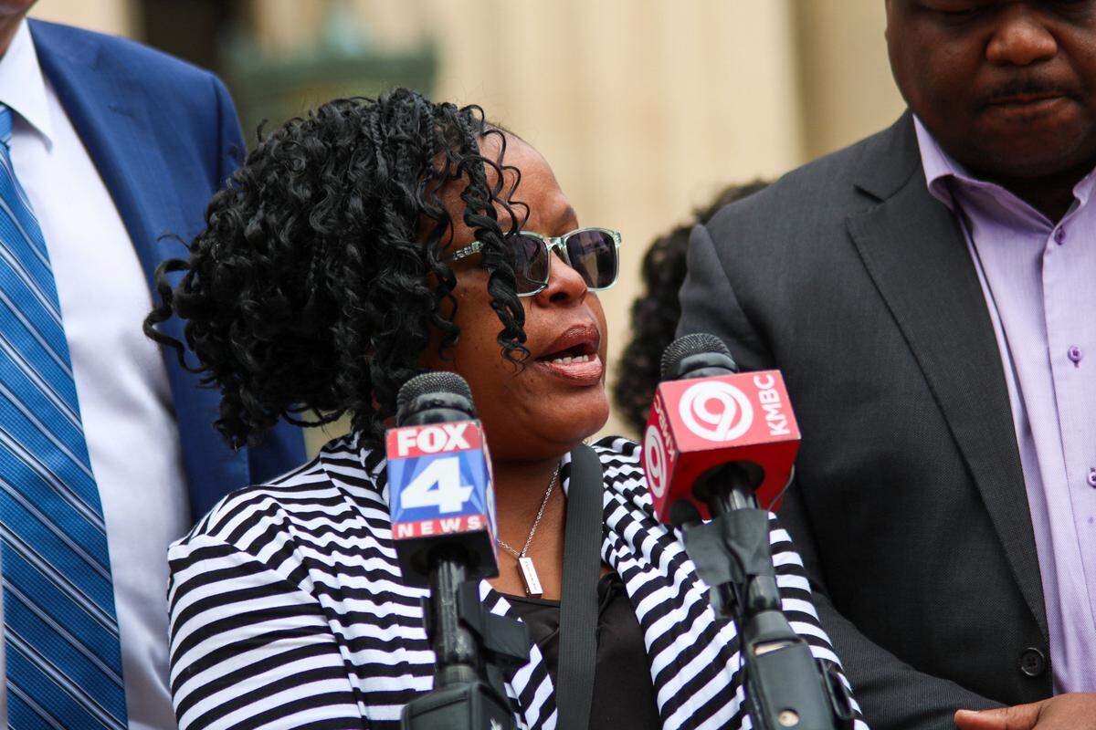 Erica Adair, sister of Charles Adiar, addresses media at the Wyandotte County Courthouse after family saw body camera footage of an altercation at the county jail that led to Charles Adair’s death.