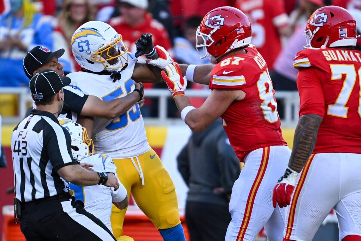 Emotions ran high and Kansas City Chiefs tight end Travis Kelce (87) and Los Angeles Chargers linebacker Del'shawn Phillips (53) get into it during the second half of the Kansas City Chiefs vs. Los Angeles Chargers NFL regular season game at Arrowhead Stadium in Kansas City on Oct. 18, 2026.