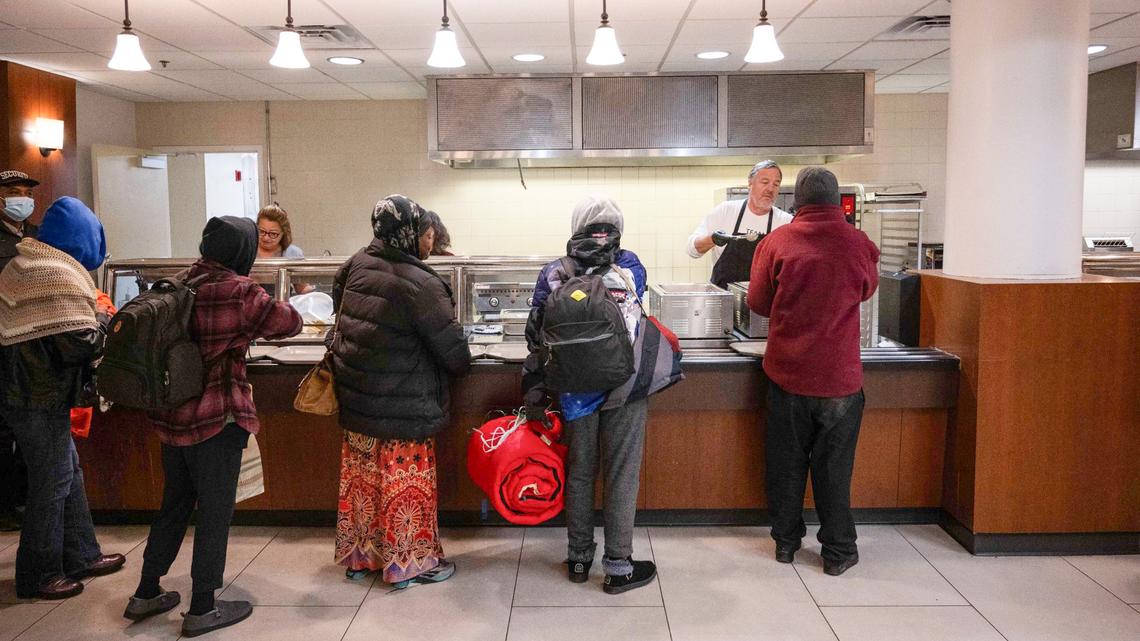 A line forms at Morning Glory Ministries, a morning breakfast program to serve the unhoused in downtown Kansas City. Some residents and businesses near the location of the program claim the concentration of unhoused people in the area has brought crime and other unwanted behaviors.