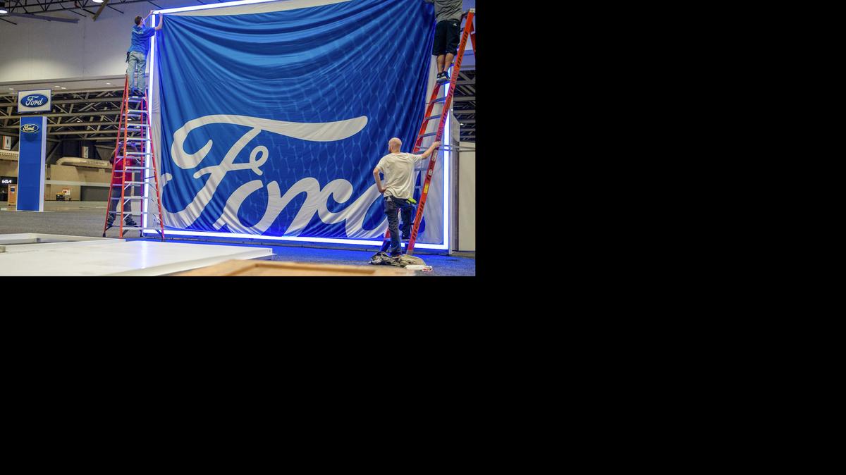 Workers set up the display for Ford products Wednesday at Bartle Hall while preparing for the opening of the Kansas City Auto Show The show, which took a break due to the pandemic, opens Thursday and continues through Sunday.