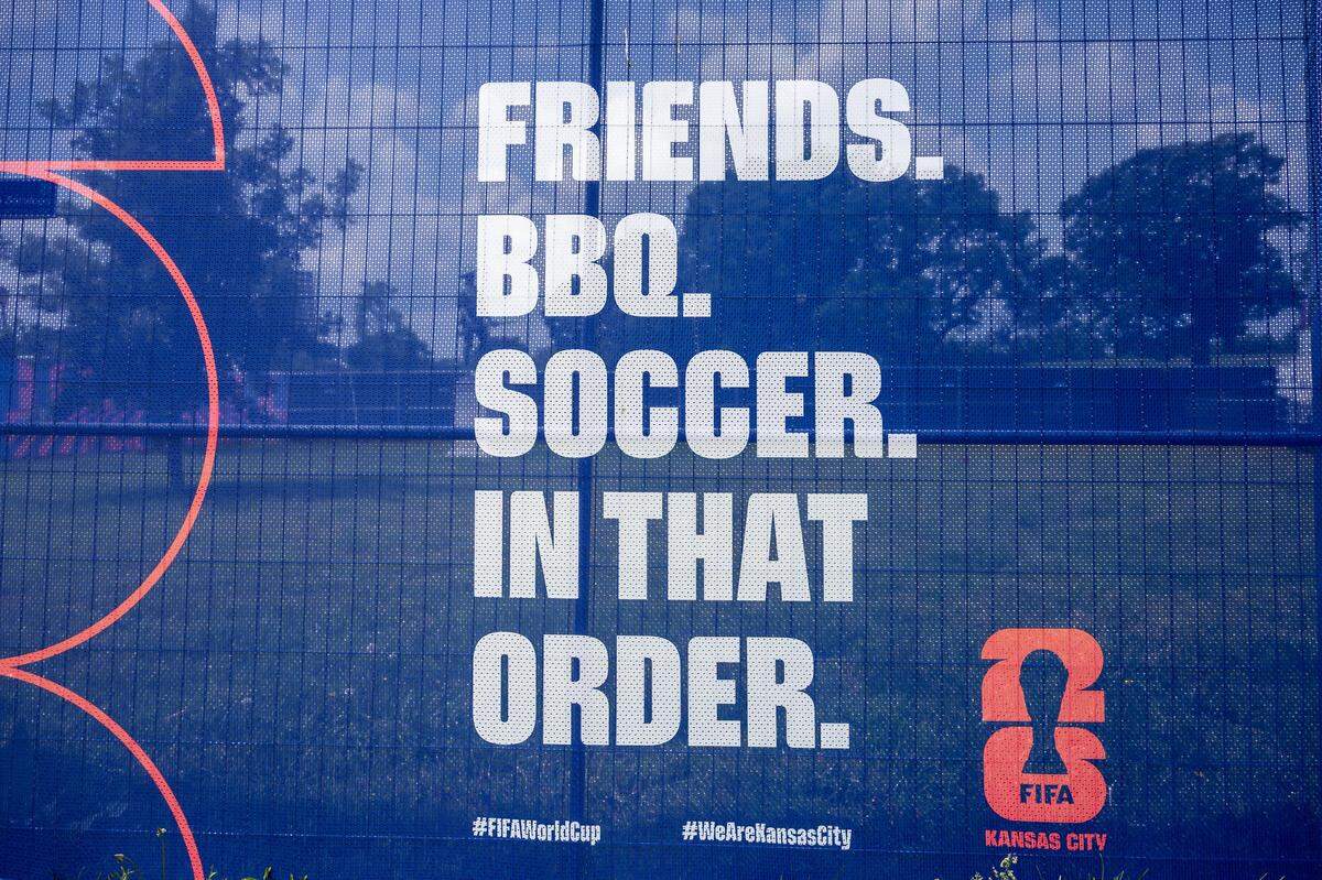 A banner is displayed on fencing surrounding the FIFA Fan Festival site at the National WWI Museum and Memorial on Wednesday, May 27, 2026, in Kansas City.