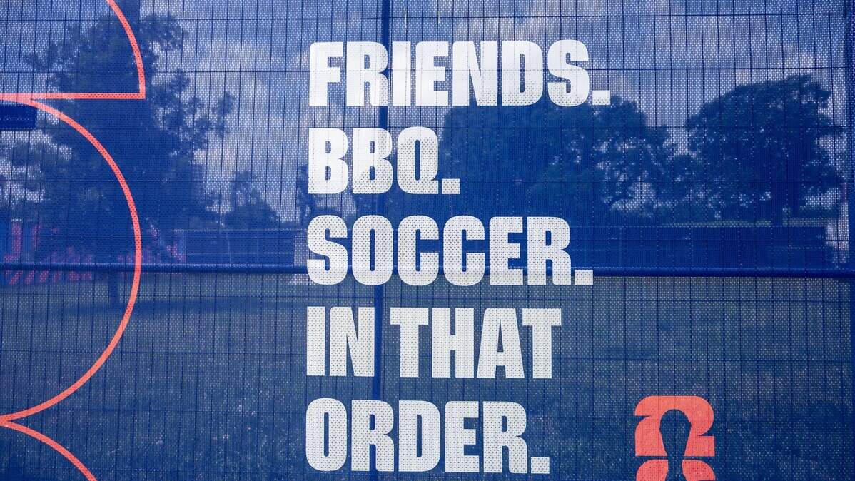 A banner is displayed on fencing surrounding the FIFA Fan Festival site at the National WWI Museum and Memorial on Wednesday, May 27, 2026, in Kansas City.