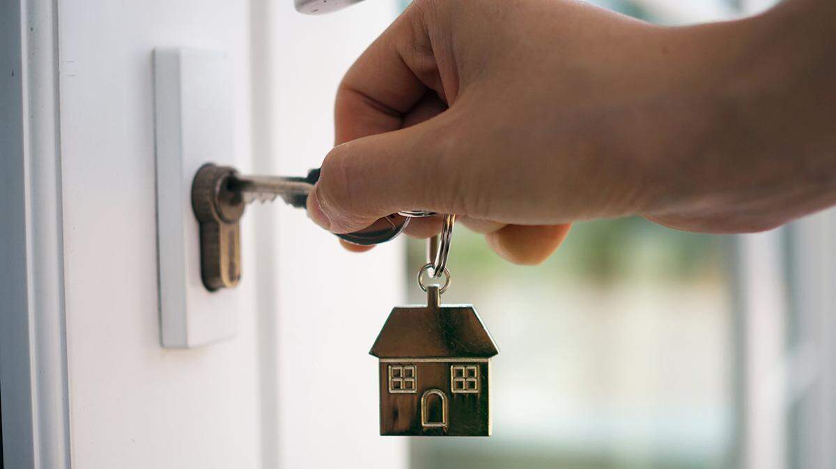 Landlord unlocks the house key for new home property tenant rent renter apartment