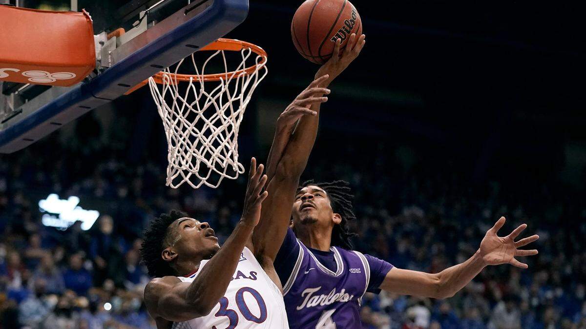 Kansas’ Ochai Agbaji (30) shoots under pressure from Tarleton State’s Tahj Small (4) during the first half of an NCAA college basketball game Friday, Nov. 12, 2021, in Lawrence, Kan. (AP Photo/Charlie Riedel)