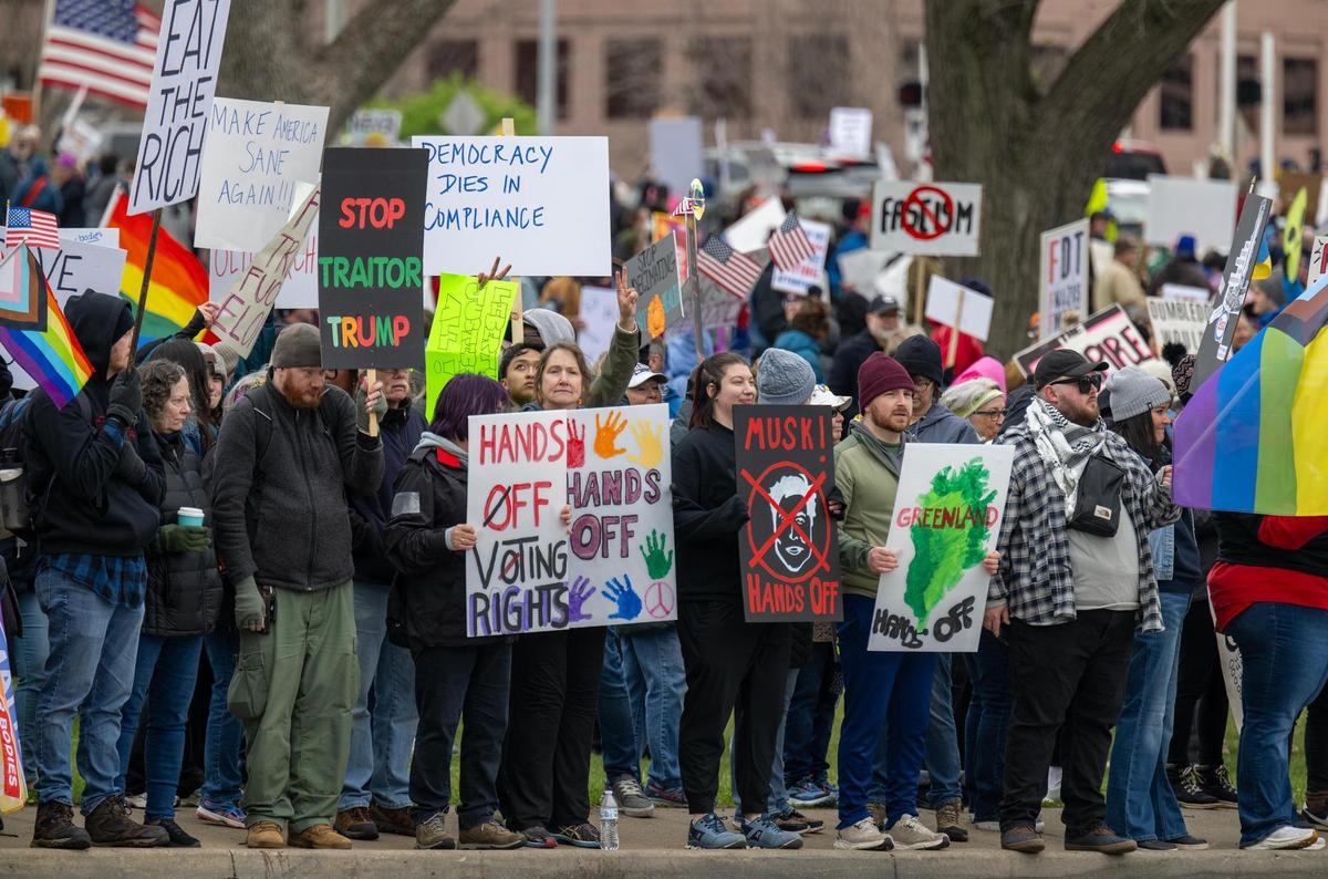 Protesters lined the street during Hands Off! Kansas City Fights Back, a peaceful pro-democracy rally that takes aim at Elon Musk and Trump administration’s policies.