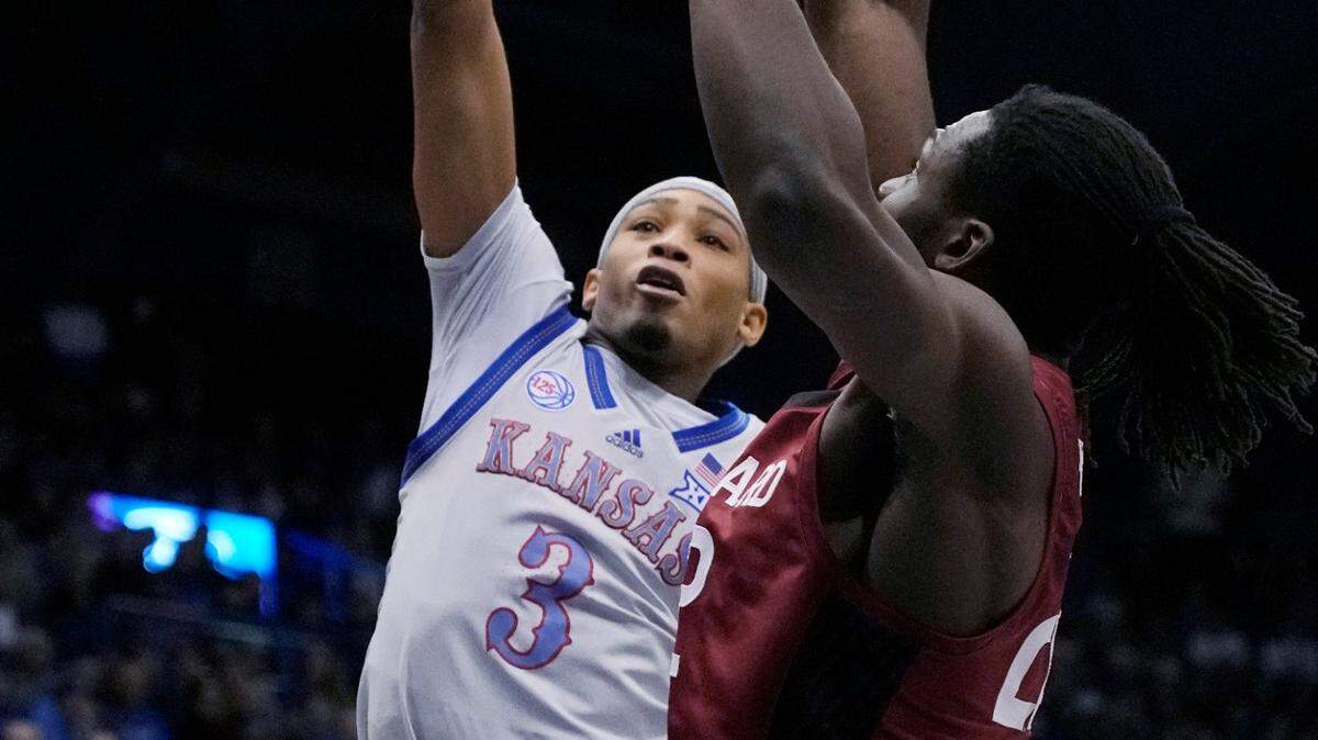 Kansas guard Dajuan Harris Jr. (3) shoots against Harvard forward Justice Ajogbor during the first half on Thursday, Dec. 22, 2022, in Lawrence, Kan.