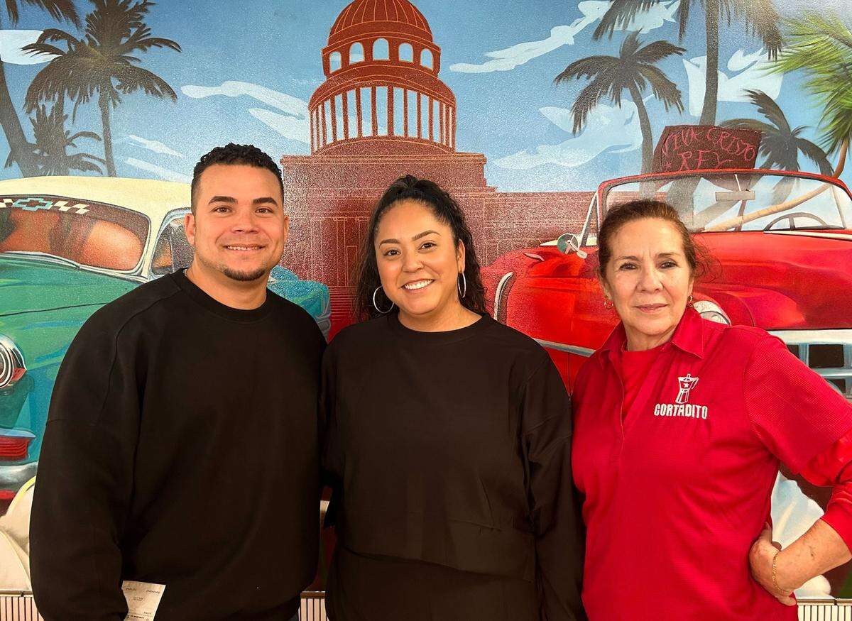 From left, Karelll Martinez, Nubia Gomez and Ysabel Corcoba stand inside their coffee shop, Cortadito.
