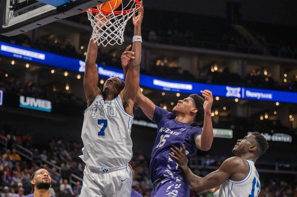 BYU Cougars forward Khadim Mboup (7) gets a putback dunk against Kansas State Wildcats forward Taj Manning (15) in the second half of the Wildcats first round game vs. the BYU Cougars in the Big 12 Men's Basketball Tournament, on Tuesday, March 10, 2026, at T-Mobile Center. The Wildcats lost to BYU, 105-91.