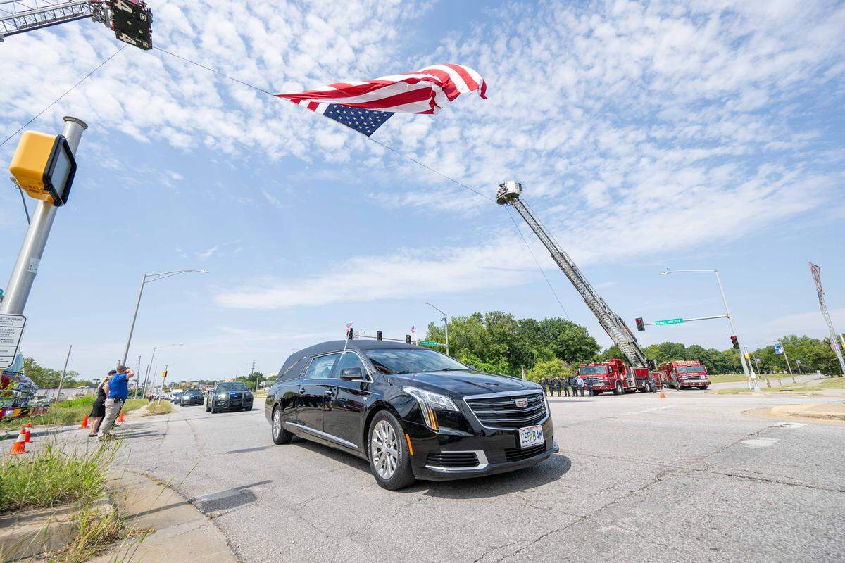The hearse carrying slain KCKPD Officer Hunter Simoncic, drives down State Ave., near the place where Simoncic was injured, on Wednesday, Sept. 3, 2025, in Kansas City, Kansas. Simoncic was killed Aug. 26 after being struck by a fleeing driver while deploying stop sticks.
