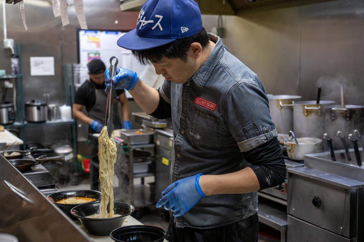 Kenichi Ota, owner of KC Craft Ramen, stirs ramen noodles in a bowl as he prepares an order on Wednesday, Oct. 29, 2025, in Overland Park.