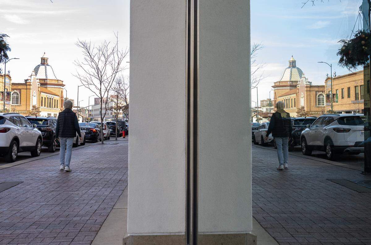 A pedestrian walks along Nichols Road at the Country Club Plaza on Tuesday, Dec. 16, 2025, in Kansas City.