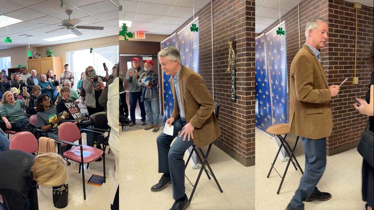 Kansas Sen. Roger Marshall walks out of a town hall in Oakley as the crowd boos on March 1, 2025.