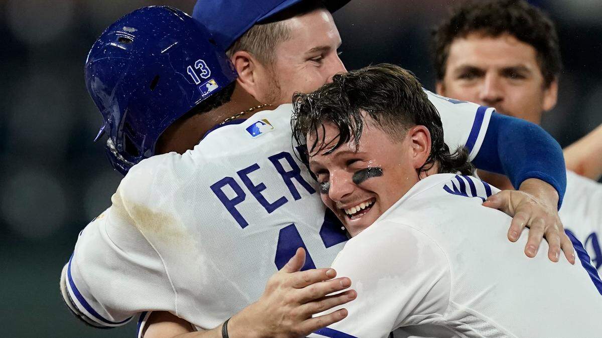 Kansas City Royals’ Salvador Perez (13) and Bobby Witt Jr. celebrate after a baseball game against the Cleveland Guardians Wednesday, Sept. 7, 2022, in Kansas City, Mo. Perez hit a sacrifice fly in the ninth inning to drive in the winning run. The Royals won 2-1. (AP Photo/Charlie Riedel)