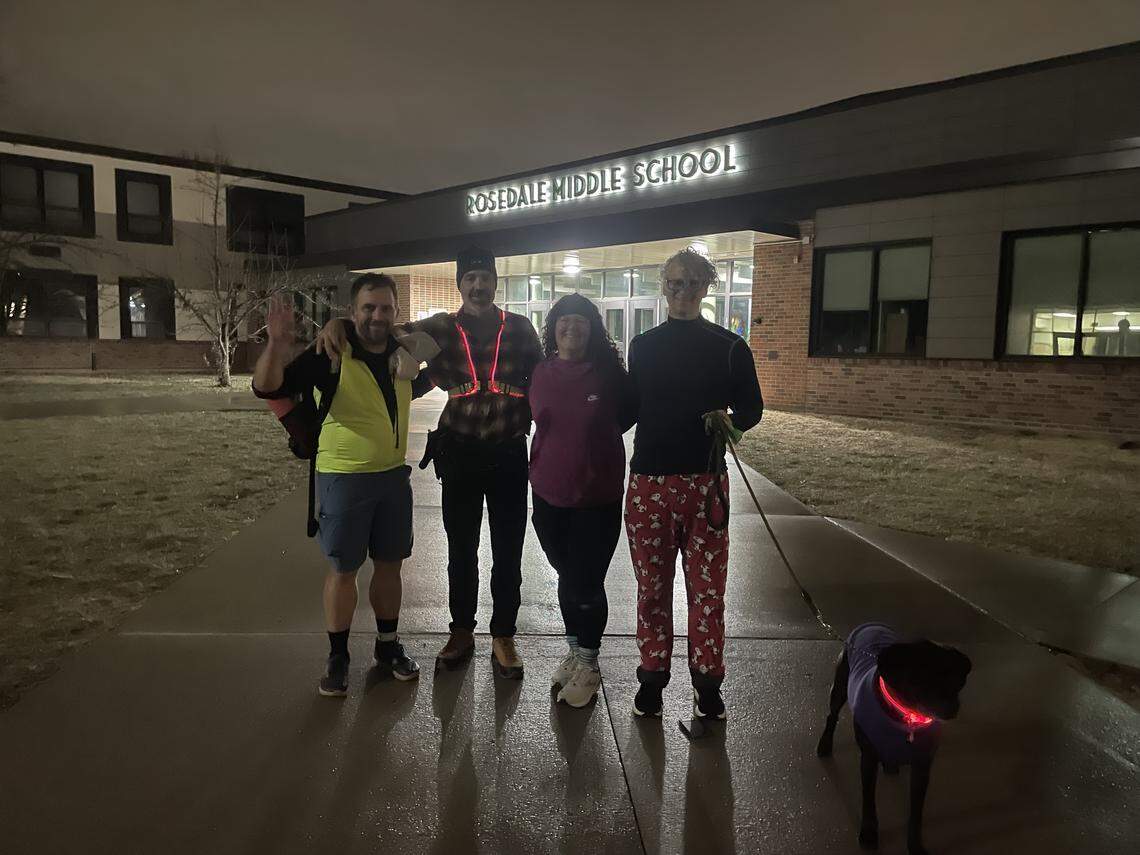 JC Van Deventer and friends Troy Paul, Raissa Johnson, Steve White and pup Birdie stand outside Rosedale Middle School on the morning of Dec. 18, 2025. Van Deventer walked from his home in Lee’s Summit to Kansas City, Kansas, overnight to raise money to support children experiencing homelessness.