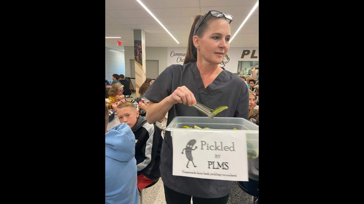 At Pleasant Lea Middle School, Jennifer Flint serves up homemade pickles.