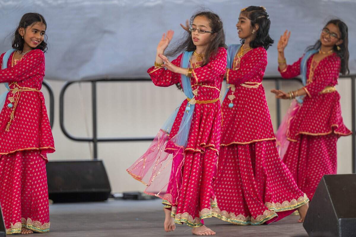 Young girls perform a traditional Indian dance at the Ethnic Enrichment Festival in Swope Park on Saturday, Aug. 16, 2025, in Kansas City. The annual festival celebrates the many different cultures and ethnicities that exist in Kansas City, with vendor booths, cultural education opportunities, and performances. Temperatures reached nearly 100 degrees.