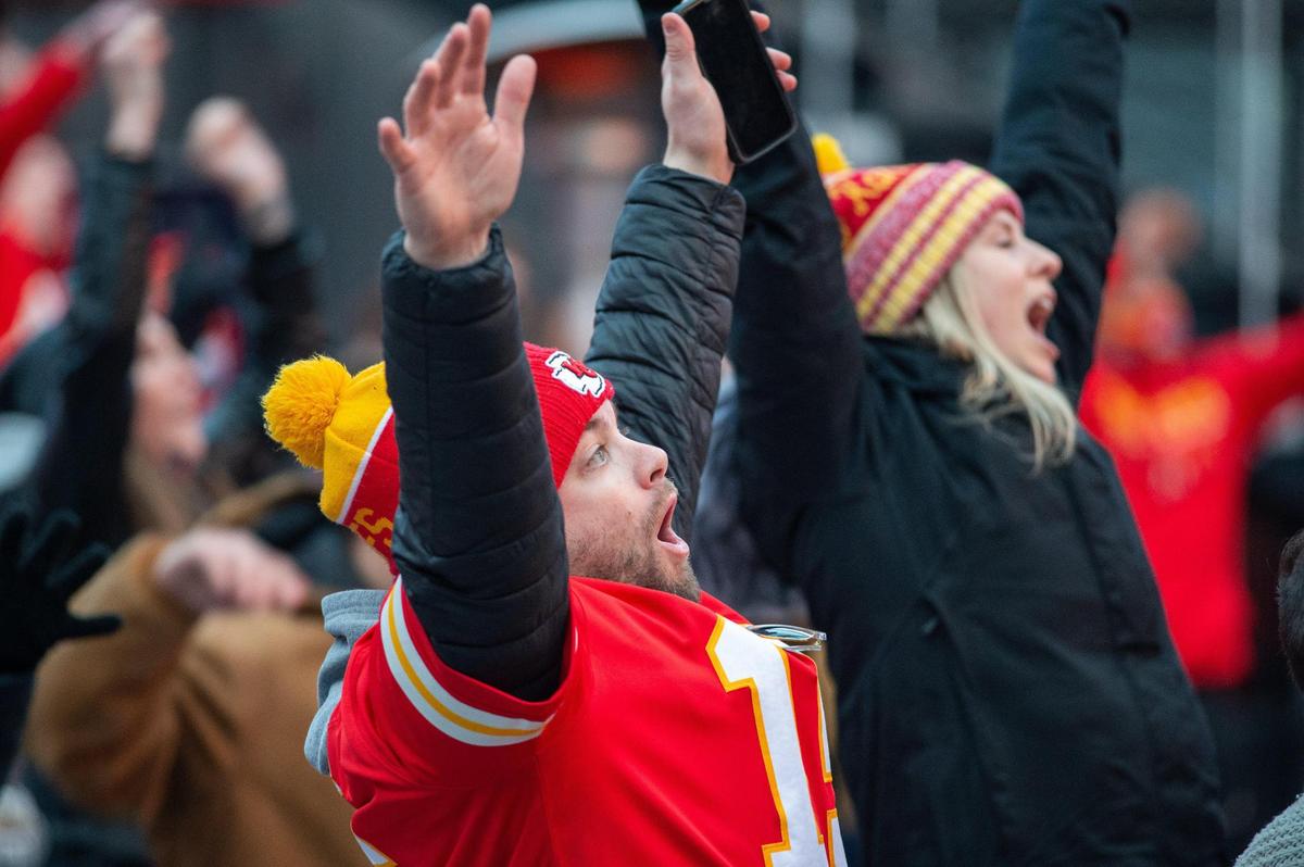 Chiefs fans celebrate after backup quarterback Chad Henne completed a 5-yard pass to Tyreek Hill to get the first down that allowed the Chiefs to run out the clock Sunday, Jan. 17, 2021.