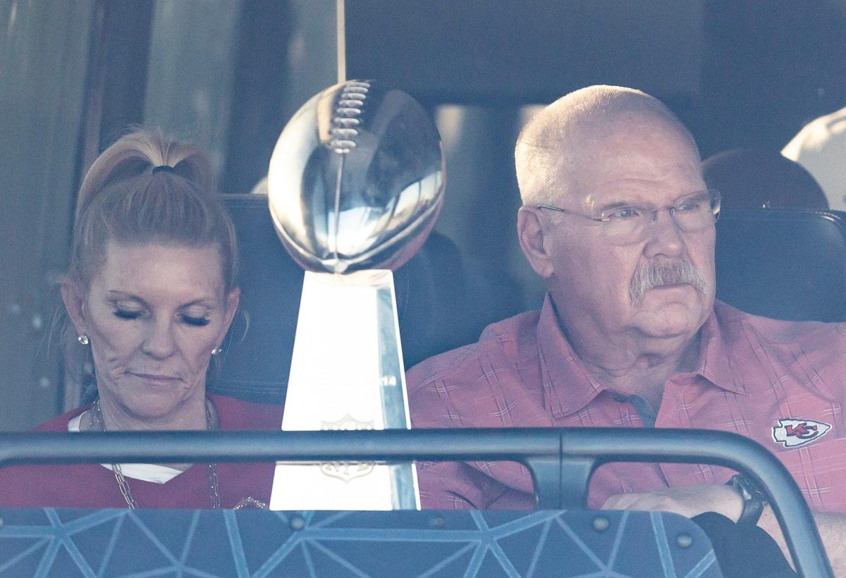 Chiefs coach Andy Reid and his wife, Tammy, sit on a charter bus with the Vince Lombardi Trophy and wait to depart Kansas City International Airport on Monday. The Kansas City Chiefs returned home after defeating the Philadelphia Eagles in Super Bowl LVII in Glendale, Ariz.