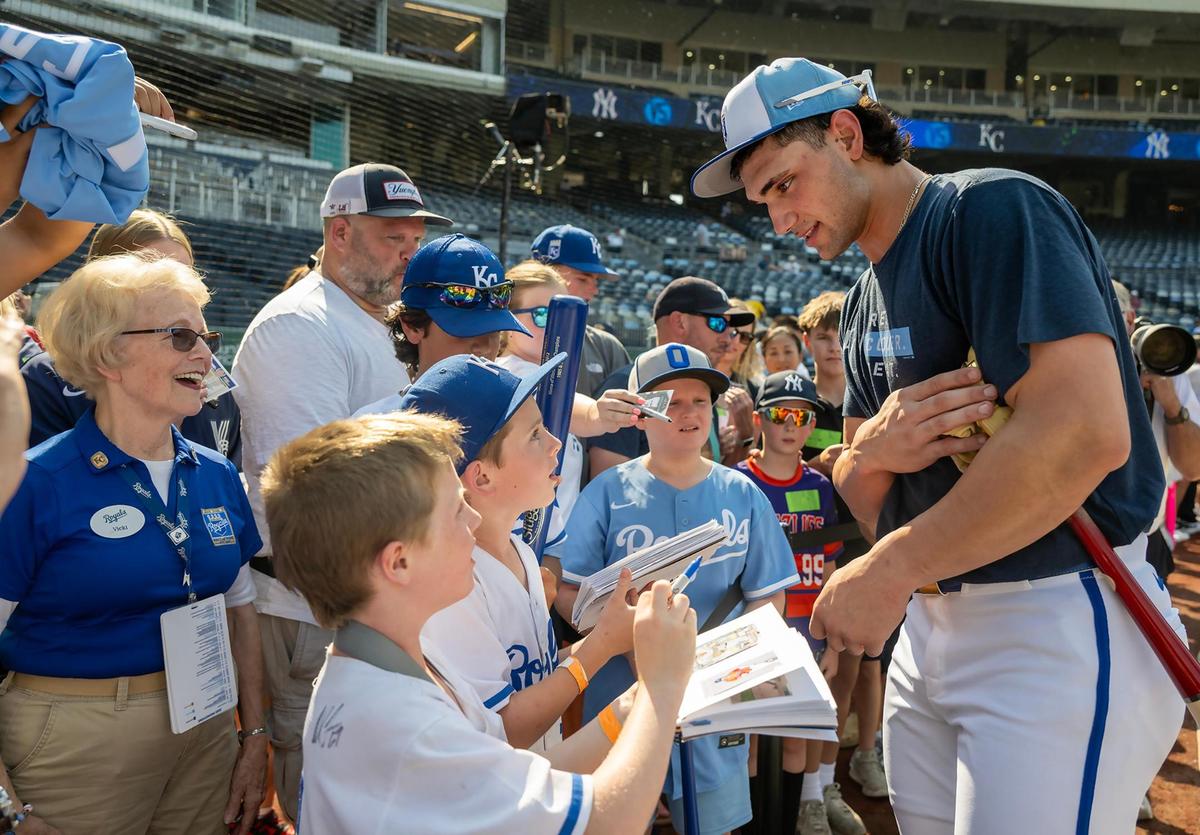 Kansas City Royals outfielder Jac Caglianone (14) signs autographs for fans before the game against the New York Yankees on Tuesday, June 10, 2025, at Kauffman Stadium in Kansas City.