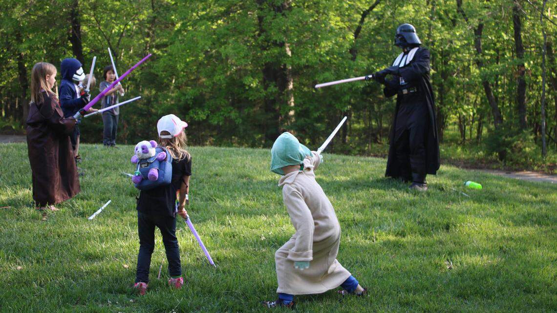 Young padawans take on Darth Vader after a light saber class at Ernie Miller’s “Star Wars” event May 3.
