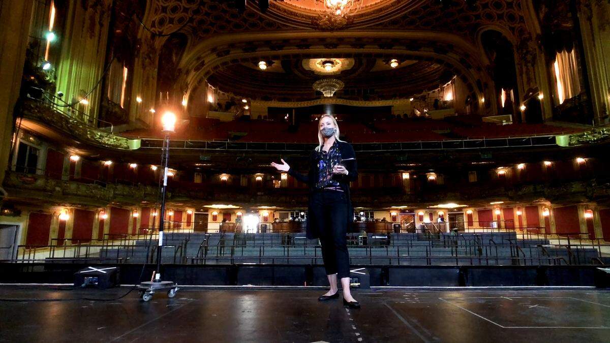 Katie Schillare, director of special events at the Midland Theatre, shows the ghost light that remained on all throughout the pandemic shutdown.