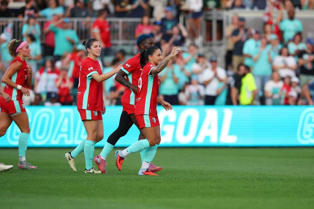 Kansas City Current star Debinha celebrates with teammates during a 2-0 win on Saturday, Sept. 20, 2025. The Current secured the NWSL Shield with the victory.
