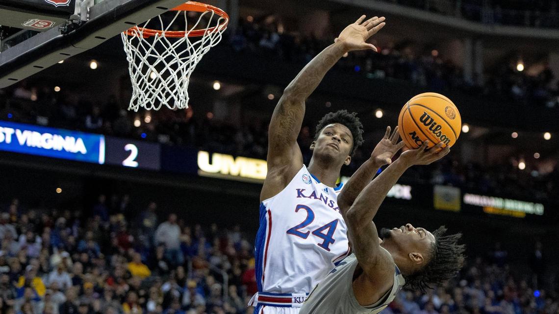 Kansas forward K.J. Adams Jr. (24) contests a shot by West Virginia guard Kedrian Johnson (0) during a second-round game in the Big 12 Tournament Thursday, March 9, 2023, in Kansas City.