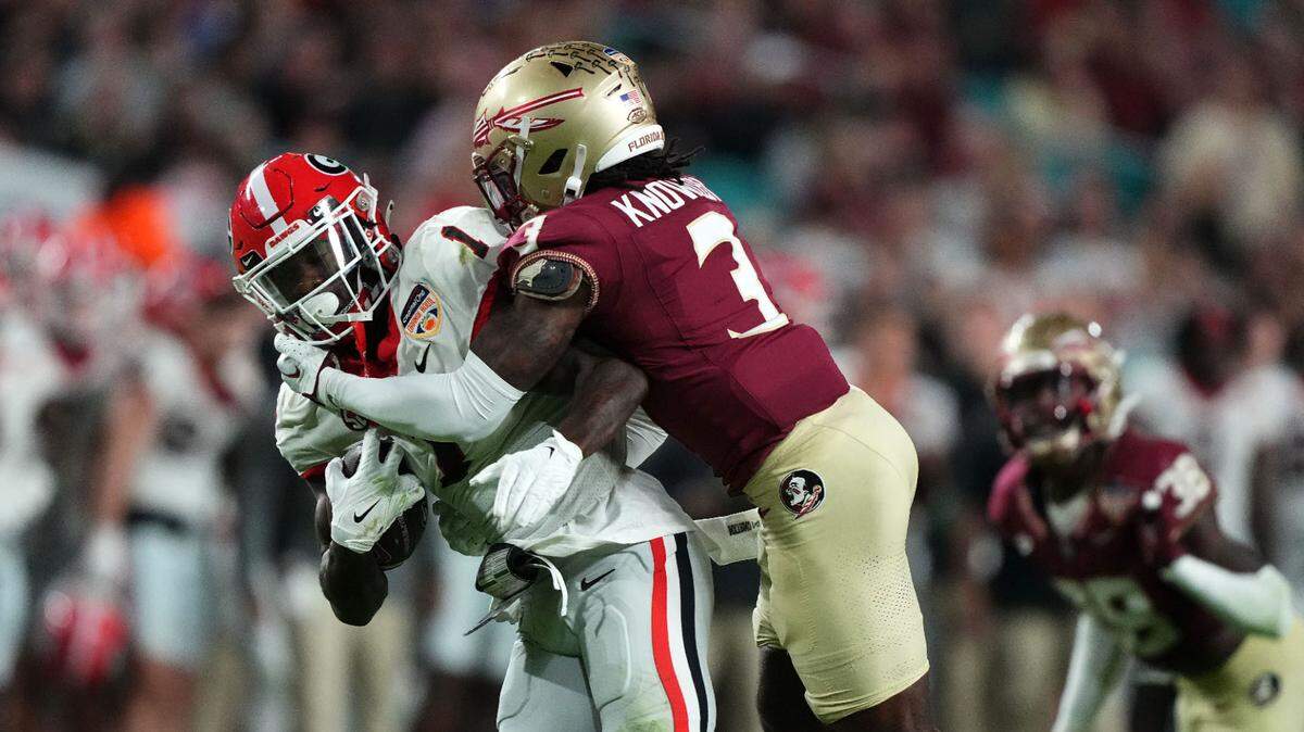 Georgia Bulldogs wide receiver Marcus Rosemy-Jacksaint was hit by Florida State Seminoles defensive back Kevin Knowles II during the 2023 Orange Bowl.