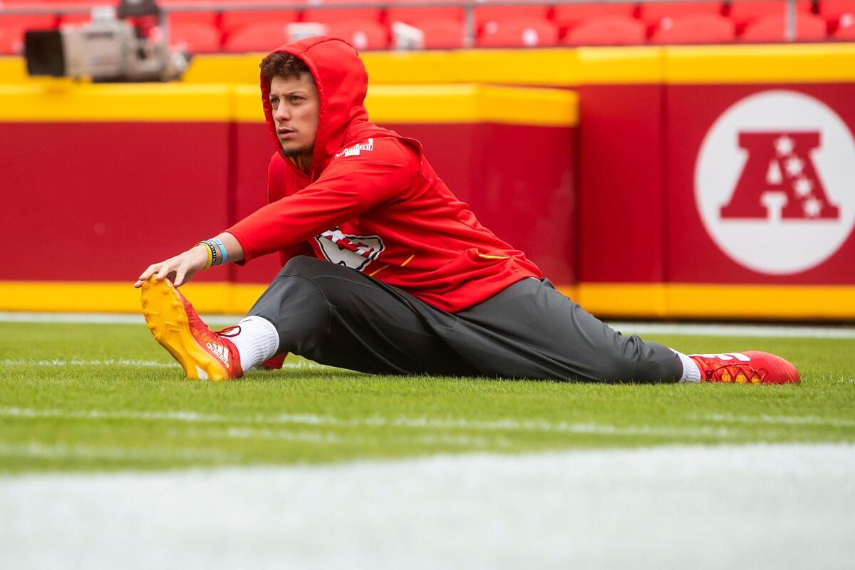 Chiefs quarterback Patrick Mahomes stretches on the field before a game this season at Arrowhead Stadium.